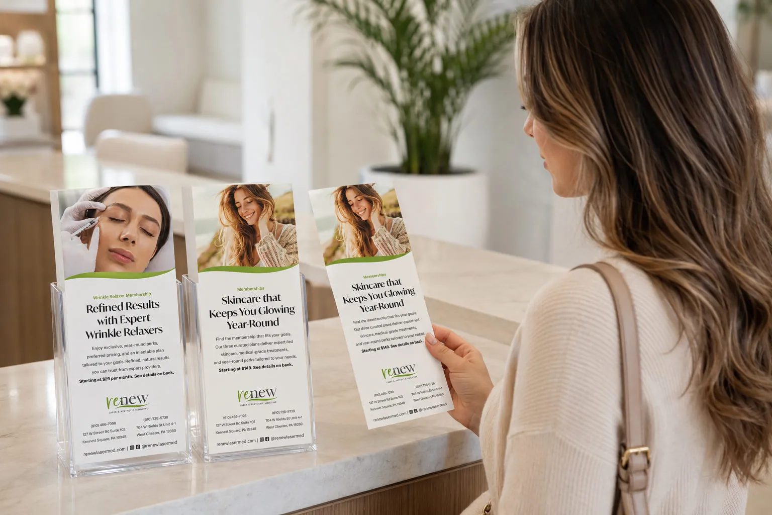 Renew Laser & Aesthetic Medicine membership rack cards displayed at a spa reception counter